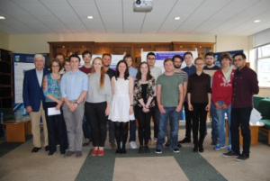 All 15 Physics Summer Internship interns and the judges gathered for the research poster competition in the Physics Common Room.