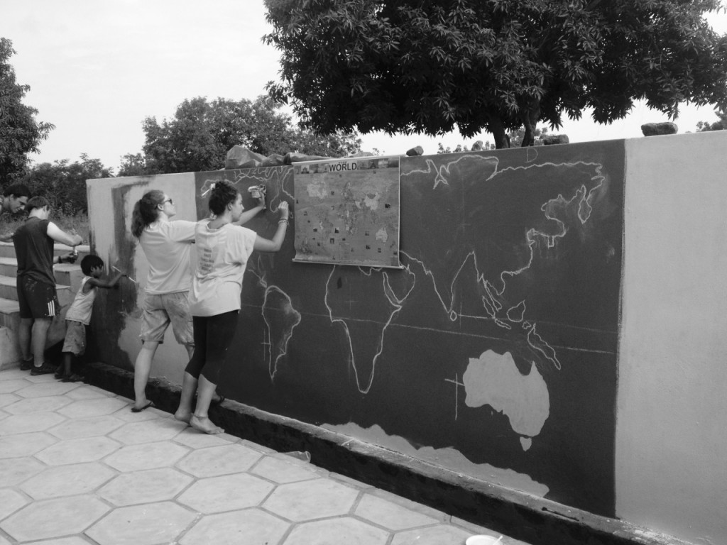 Volunteers and children painting a mural at Care & Share India, UCDVO 2013