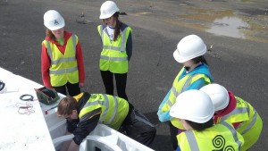 Oisín connecting the summators to the cables rising out of the ground below